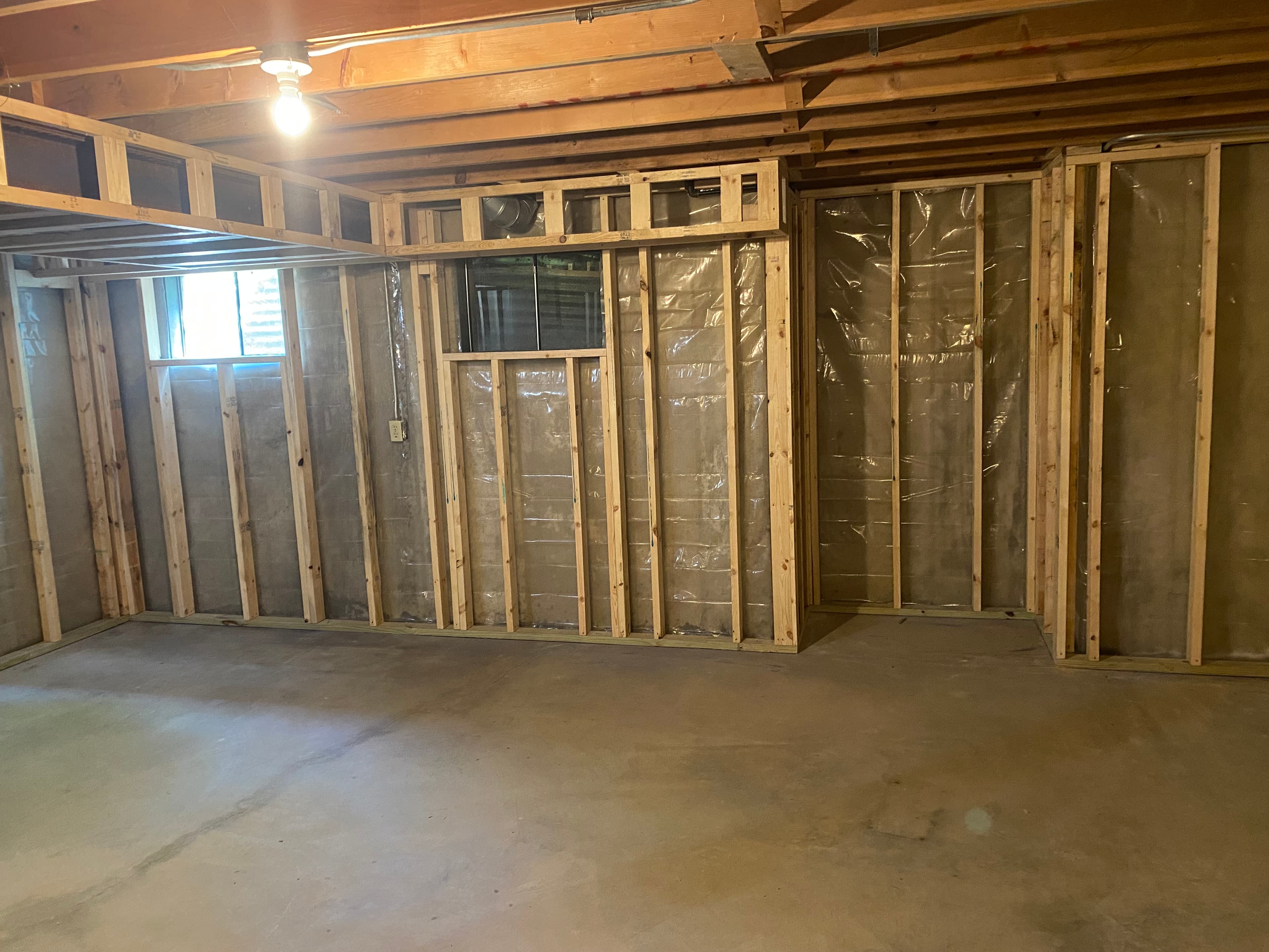 Interior renovation in progress, showing timber framing and open ceiling joists.